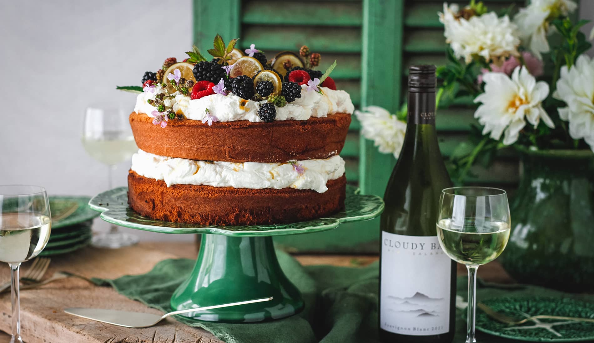 Layered cake beside bottle and glass of Cloudy Bay Sauvignon Blanc
